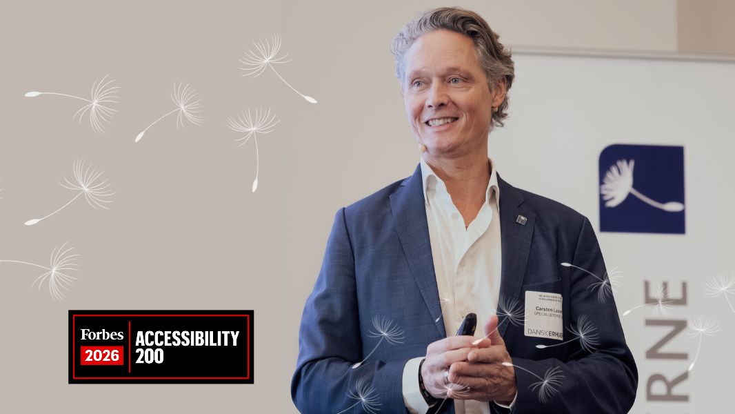Carsten Lassen of Specialisterne speaking at an event, with white dandelion graphics and a Forbes 2026 Accessibility 200 badge.